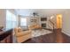 Spacious living room with hardwood floors, ceiling fan, stairs, and natural light at 5535 Spindlewood Ct, Durham, NC 27703