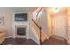 Inviting living room featuring a fireplace, a TV, and stairs to the upper level at 5535 Spindlewood Ct, Durham, NC 27703