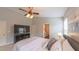 Bright main bedroom featuring neutral walls, carpet floors, and a ceiling fan at 5535 Spindlewood Ct, Durham, NC 27703