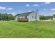 Backyard showcasing a deck and light blue single-Gathering home, with a chimney at 5849 Rocking Chair Dr, Youngsville, NC 27596