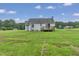 Light blue single-Gathering home in a backyard, with a deck and ample space for outdoor activities at 5849 Rocking Chair Dr, Youngsville, NC 27596