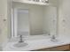 Bathroom featuring a double vanity with a large mirror and bright lighting at 5849 Rocking Chair Dr, Youngsville, NC 27596