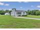 Cozy home featuring a well-manicured lawn and a convenient driveway, offering comfort and practicality at 5849 Rocking Chair Dr, Youngsville, NC 27596