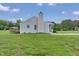 Exterior view of a light blue single-Gathering home, showcasing a deck and a chimney at 5849 Rocking Chair Dr, Youngsville, NC 27596