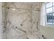 Accessible shower with marble-style walls and grab bars at 5849 Rocking Chair Dr, Youngsville, NC 27596