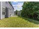 Exterior view of a home's backyard and lush green lawn at 5940 Brambleton Ave, Raleigh, NC 27610