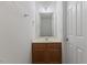 Bathroom featuring a sink with wooden cabinets and neutral walls at 5940 Brambleton Ave, Raleigh, NC 27610
