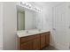 Bright bathroom with a double vanity, neutral tones, a large mirror and updated fixtures at 5940 Brambleton Ave, Raleigh, NC 27610