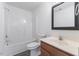 Bathroom featuring a toilet, bathtub and a sink with wooden drawers at 5940 Brambleton Ave, Raleigh, NC 27610