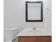 Bathroom featuring a toilet and sink with a mirror at 5940 Brambleton Ave, Raleigh, NC 27610