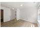 Sunlit bedroom with wood-look floors, neutral walls, and ample natural light at 5940 Brambleton Ave, Raleigh, NC 27610