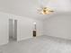 Large bedroom featuring neutral carpet, ceiling fan, ensuite bathroom, and walk in closet at 5940 Brambleton Ave, Raleigh, NC 27610