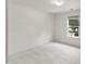 Bright, neutral bedroom with carpet and a window with tree views at 5940 Brambleton Ave, Raleigh, NC 27610