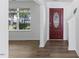 Bright entryway with wood floors, a decorative front door, and natural light at 5940 Brambleton Ave, Raleigh, NC 27610