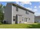 Back exterior of home features a gray siding, fenced yard, and a patio at 5940 Brambleton Ave, Raleigh, NC 27610