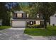 Traditional home showcasing a two-car garage, symmetrical windows, and landscaped front yard at 5940 Brambleton Ave, Raleigh, NC 27610