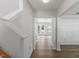 Hallway with wood floors offering a view of a bright, open room beyond the doorway at 5940 Brambleton Ave, Raleigh, NC 27610