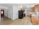 Spacious kitchen with wooden cabinets, sleek black refrigerator, and laminate flooring at 5940 Brambleton Ave, Raleigh, NC 27610