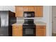Close-up of kitchen appliances and countertops with wooden cabinets at 5940 Brambleton Ave, Raleigh, NC 27610