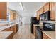 Bright kitchen flowing into the living area, featuring wood cabinets and modern appliances at 5940 Brambleton Ave, Raleigh, NC 27610