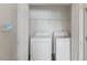 Laundry closet featuring a washing machine and dryer with shelving at 5940 Brambleton Ave, Raleigh, NC 27610