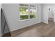Neutral living room with wood floors and natural light streaming in from large window at 5940 Brambleton Ave, Raleigh, NC 27610