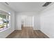 Open-concept living room with wood-look floors and a staircase visible in the background at 5940 Brambleton Ave, Raleigh, NC 27610