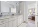 Elegant bathroom featuring a double vanity, ample storage, and a doorway that leads to a comfortable bedroom at 601 Culpepper Ct, Durham, NC 27712