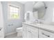 Bright bathroom featuring a white vanity with quartz countertop and a large oval mirror at 601 Culpepper Ct, Durham, NC 27712