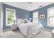 Cozy bedroom featuring bright windows, a ceiling fan, and carpeted floors at 601 Culpepper Ct, Durham, NC 27712