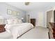 Serene bedroom with white bedding, neutral walls, and dark wood dresser; creating a calming retreat at 601 Culpepper Ct, Durham, NC 27712