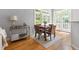 Cozy dining area with french doors and wood floors, bathed in natural light from the surrounding greenery at 601 Culpepper Ct, Durham, NC 27712