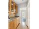 Hallway with hardwood floors and natural wood cabinets, leading to an office space at 601 Culpepper Ct, Durham, NC 27712