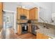 Well-equipped kitchen boasting granite counters, stainless steel appliances, and wood cabinetry at 601 Culpepper Ct, Durham, NC 27712