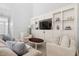 Bright living room featuring a wall of built-in shelving and comfortable seating at 601 Culpepper Ct, Durham, NC 27712