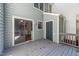 View of back deck including door to the house with sliding glass door and exterior door to storage space at 6513 Hearthstone Dr, Raleigh, NC 27615