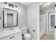 Bathroom with large framed mirror, white vanity, and shower-tub combination at 6513 Hearthstone Dr, Raleigh, NC 27615