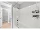 Bathroom features white tiled shower-tub combination and tiled flooring at 6513 Hearthstone Dr, Raleigh, NC 27615