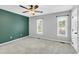 Spacious bedroom with two windows for natural light, and ceiling fan at 6513 Hearthstone Dr, Raleigh, NC 27615