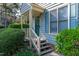 Inviting townhome entrance with stairs leading to the front door and blooming flowers at 6513 Hearthstone Dr, Raleigh, NC 27615