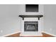 Elegant fireplace with a white brick surround and a modern black mantel, ideal for cozy evenings at 6513 Hearthstone Dr, Raleigh, NC 27615