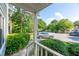 View of front yard featuring manicured bushes, green trees and street parking with car at 6513 Hearthstone Dr, Raleigh, NC 27615
