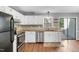 Modern kitchen with stainless steel appliances, granite countertops, and ample cabinet space at 6513 Hearthstone Dr, Raleigh, NC 27615