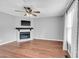 Inviting living room with a fireplace, hardwood floors, and a ceiling fan for added comfort at 6513 Hearthstone Dr, Raleigh, NC 27615