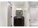 Bathroom features a vanity with dark wood cabinet, black countertop and a framed mirror at 7315 Sandy Creek Dr # 7, Raleigh, NC 27615