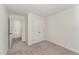 This bedroom features neutral carpet, a double door closet and access to other living areas at 7315 Sandy Creek Dr # 7, Raleigh, NC 27615