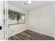 Bright, clean room with wood floors, white walls, and a large window for natural light at 7315 Sandy Creek Dr # 7, Raleigh, NC 27615