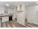 Bright kitchen with white cabinets, modern appliances, and stylish wood-look floors at 7315 Sandy Creek Dr # 7, Raleigh, NC 27615