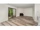 Bright living room features a fireplace, sliding glass doors, and modern gray floors at 7315 Sandy Creek Dr # 7, Raleigh, NC 27615