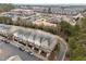 Aerial view of townhomes with colorful facades near parking, playground and landscaping at 763 Blossom Grove Dr, Cary, NC 27519